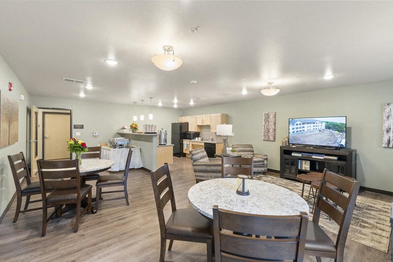 a living room with a table and chairs and a television