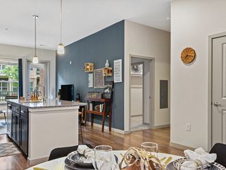 View of living room with kitchen at The Slate at Andover Apartments in Andover MA