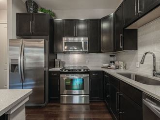 Kitchen with dark cabinets at Ascent at City Centre