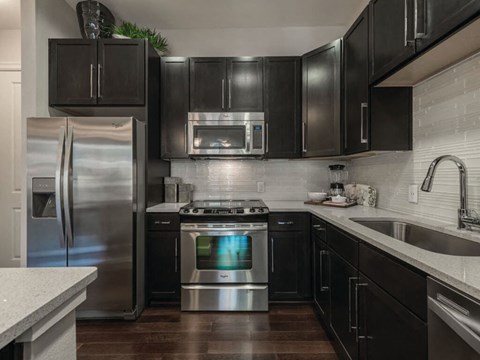 Kitchen with dark cabinets at Ascent at City Centre