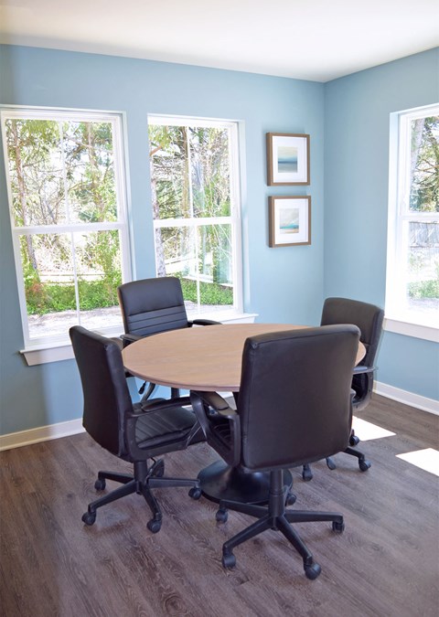 a conference room with a table and chairs