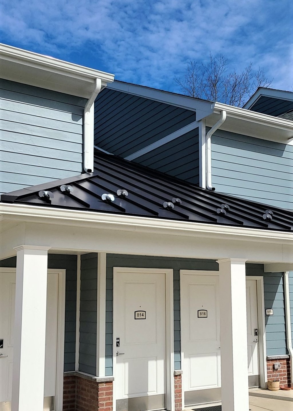 the front of a house with a black roof