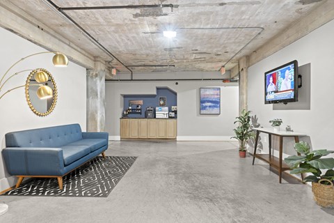 a living room with a blue couch and a tv