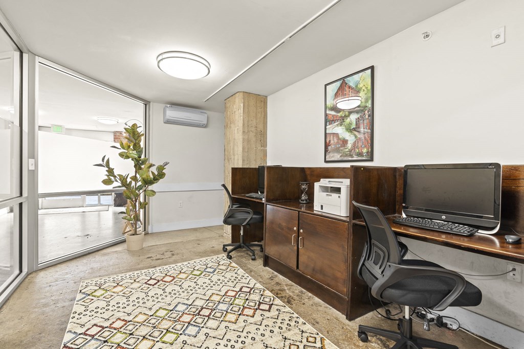 a home office with a desk and a television