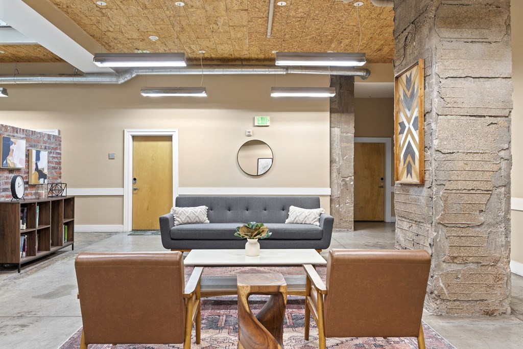 a living room with a couch and chairs and a table