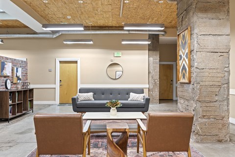 a living room with a couch and chairs and a table