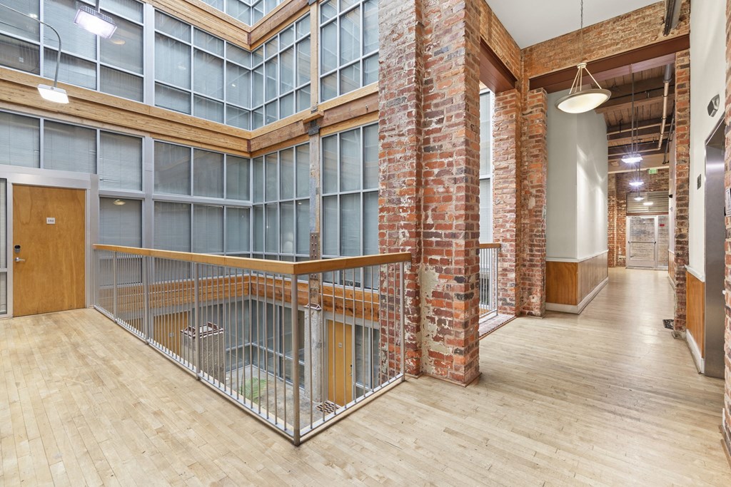the interior of an empty building with a staircase and a metal gate