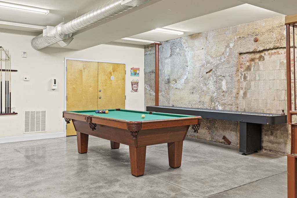 a games room with a pool table and a wall