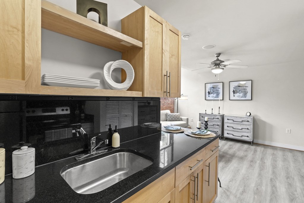a kitchen with a black counter top and a sink