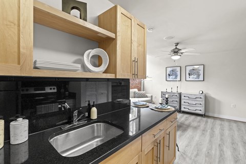 a kitchen with a black counter top and a sink