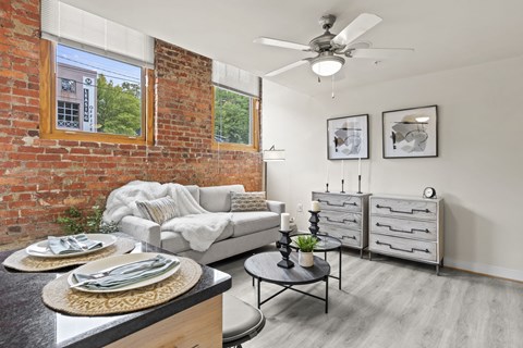 a living room with a couch and a ceiling fan