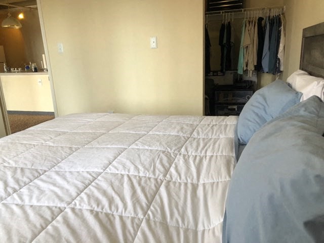 a bedroom with a large bed and a closet