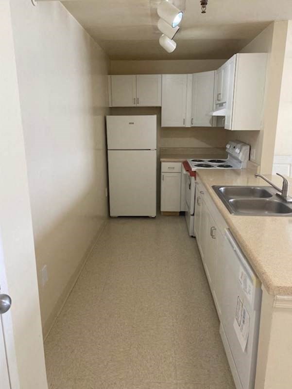 a kitchen with a sink and a refrigerator
