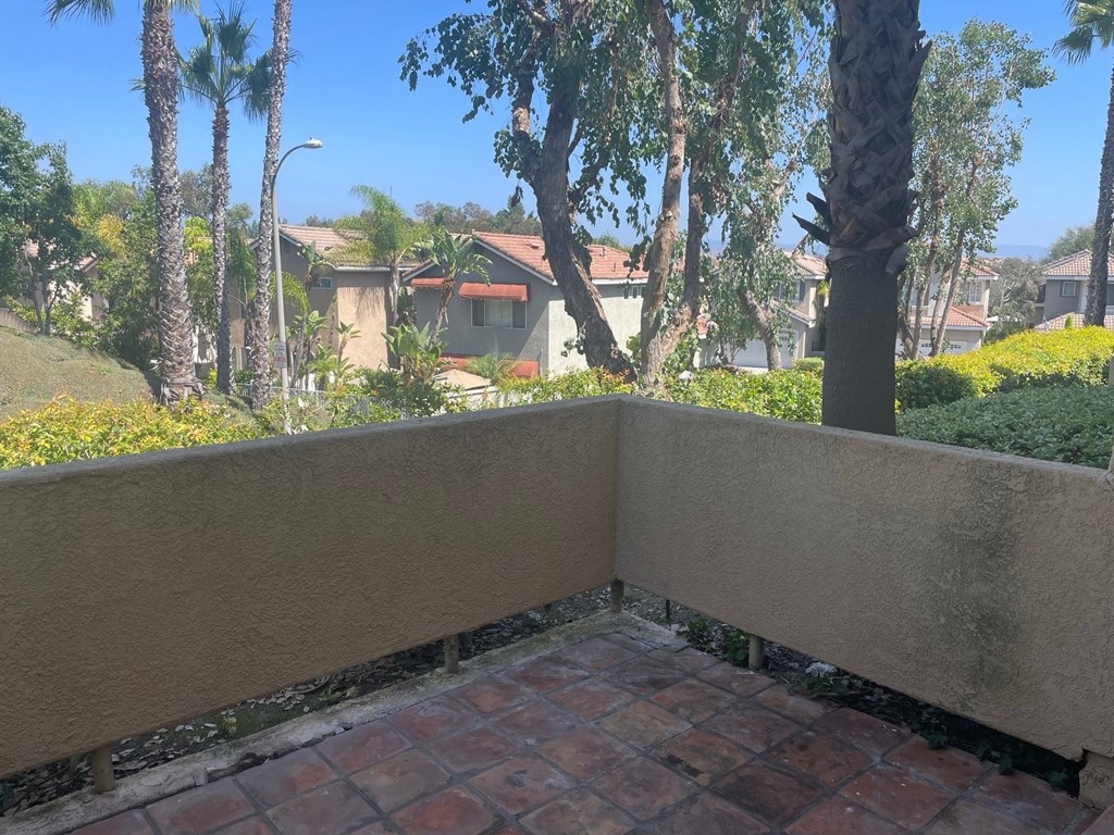 a balcony or terrace with a garden and trees