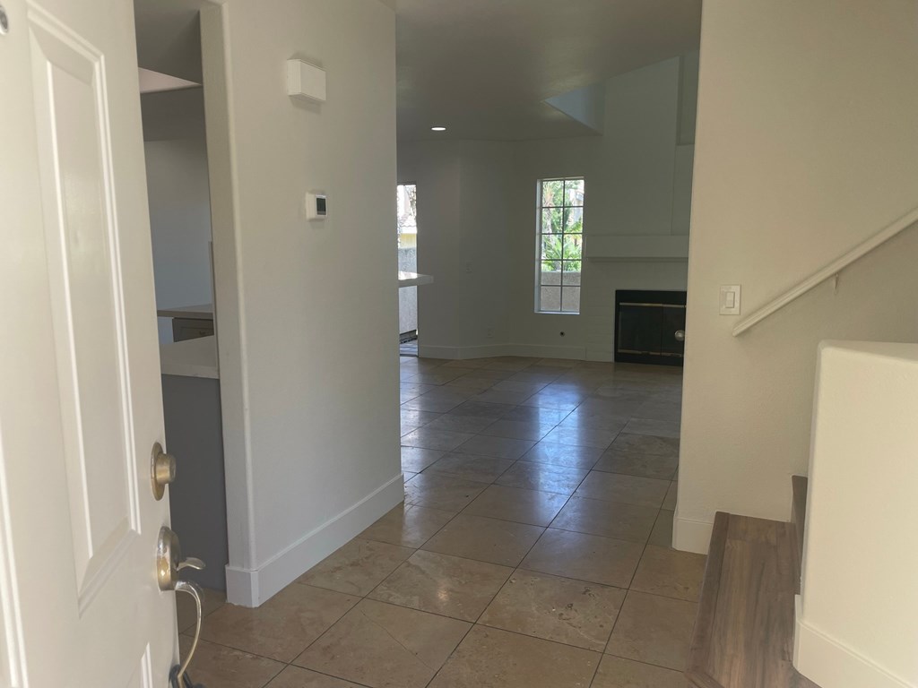 a view from the kitchen into the living room and the family room