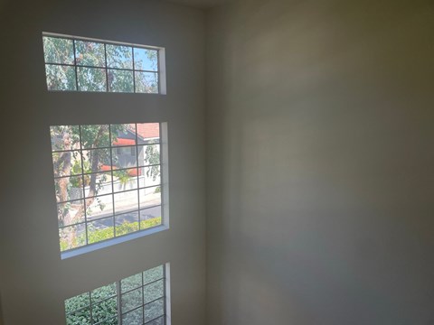 a view of a window in a room with white walls