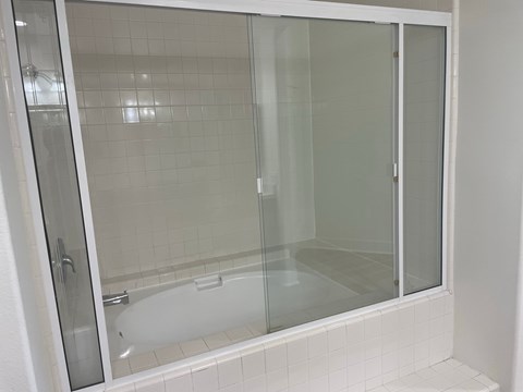 a shower with a glass door in a bathroom