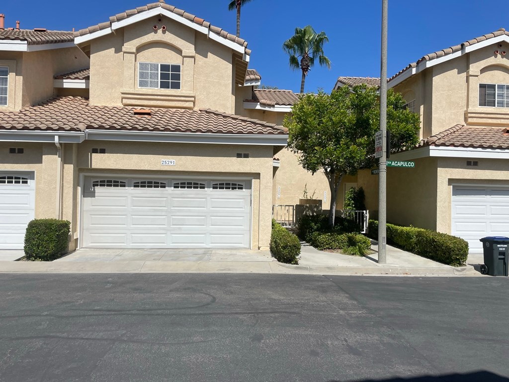 a house with two garage doors in front of it