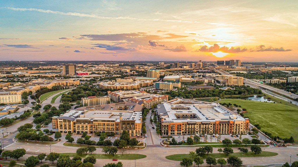 an aerial view of the city at sunset