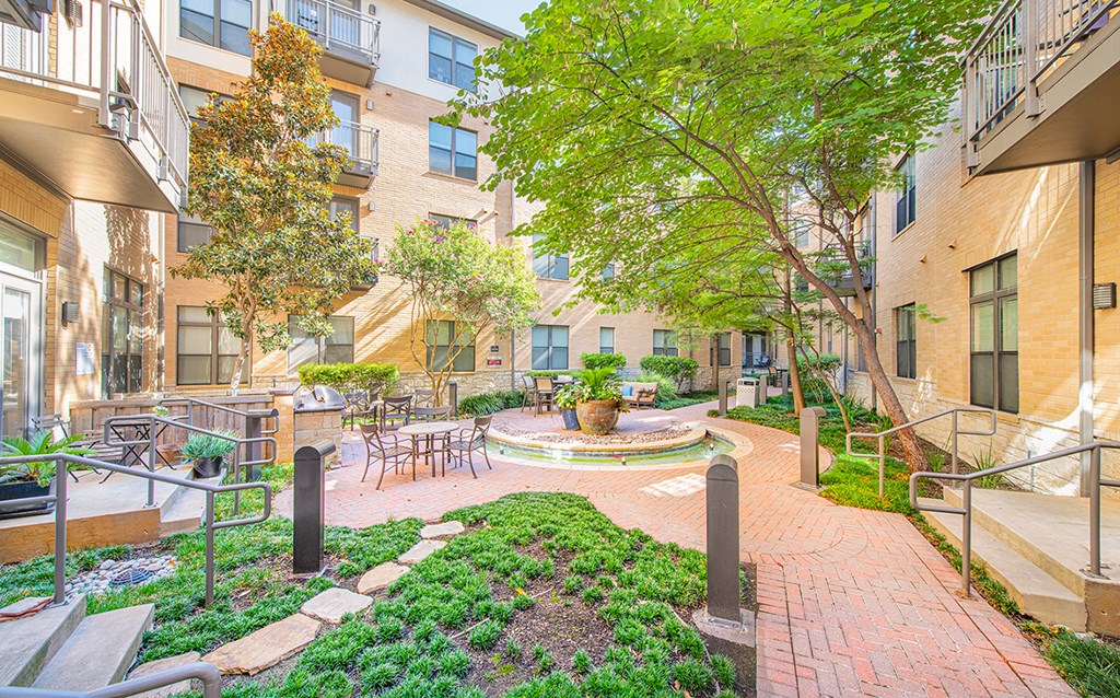 a courtyard with a fountain in the middle of an apartment building