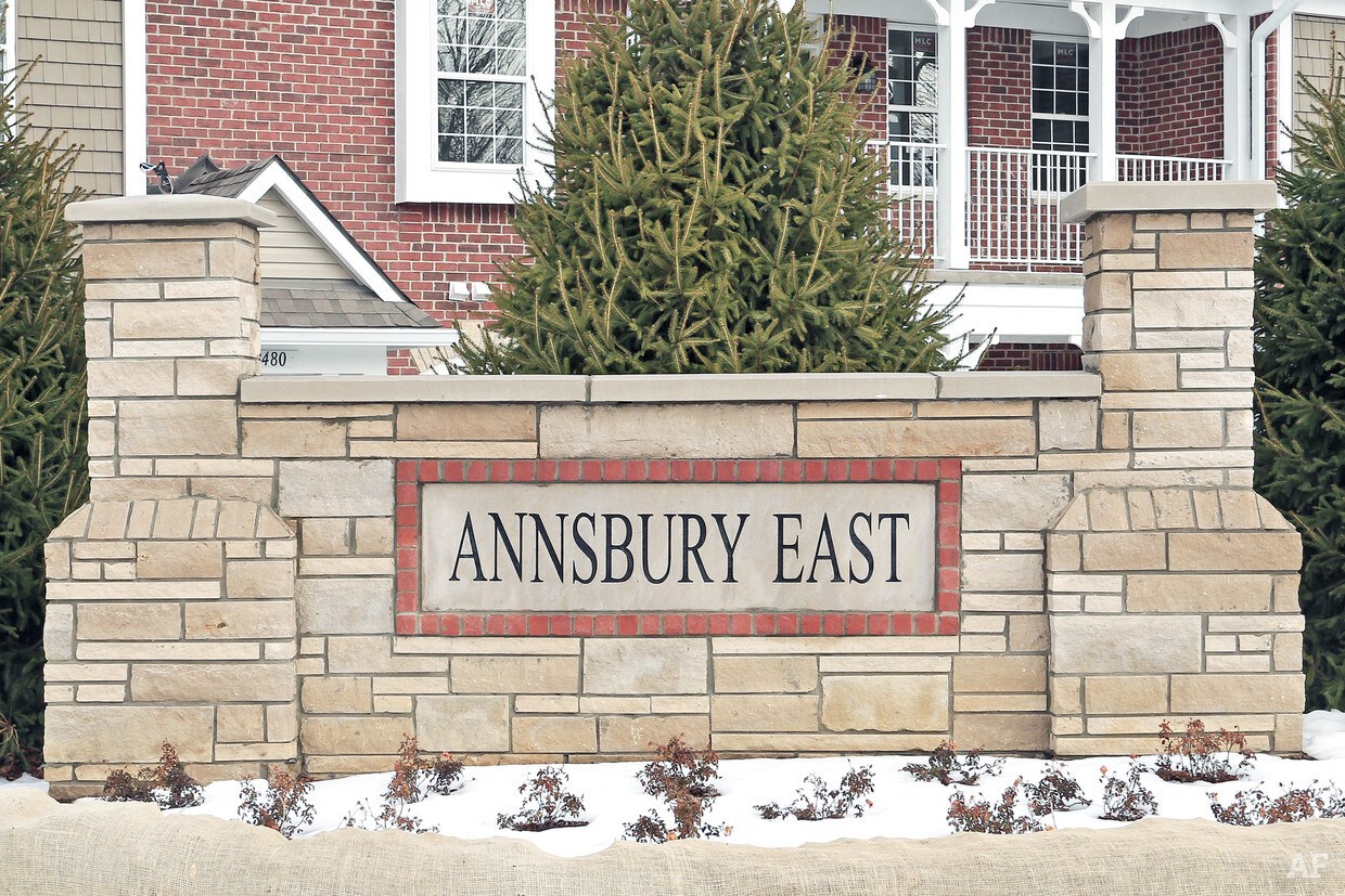 a stone wall with a sign that reads amsbury east