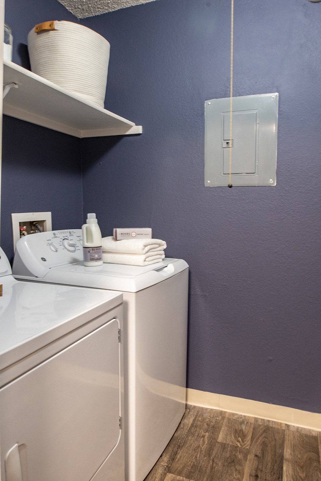 a washer and dryer in a laundry room with a blue wall