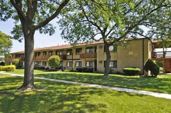 a large brick building with trees in front of it