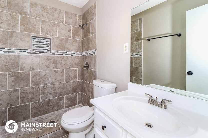 a bathroom with a sink toilet and a shower