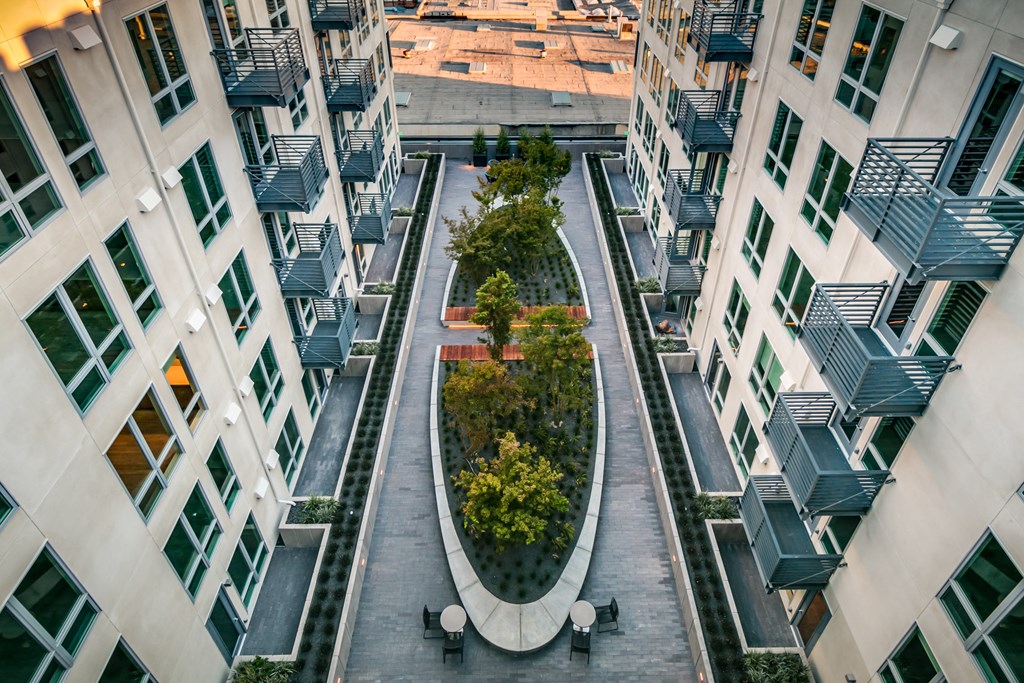 an aerial view of an office building with trees in the center