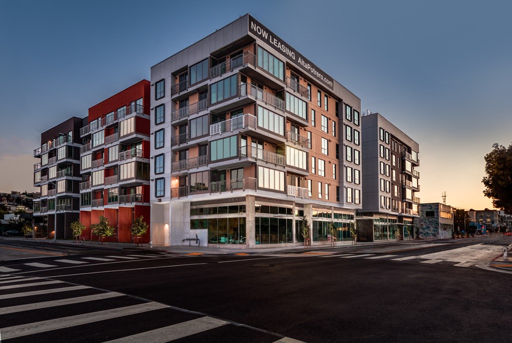 a building on the corner of a street at dusk