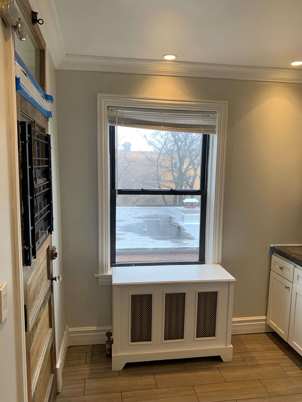 a window in a kitchen with a radiator under it