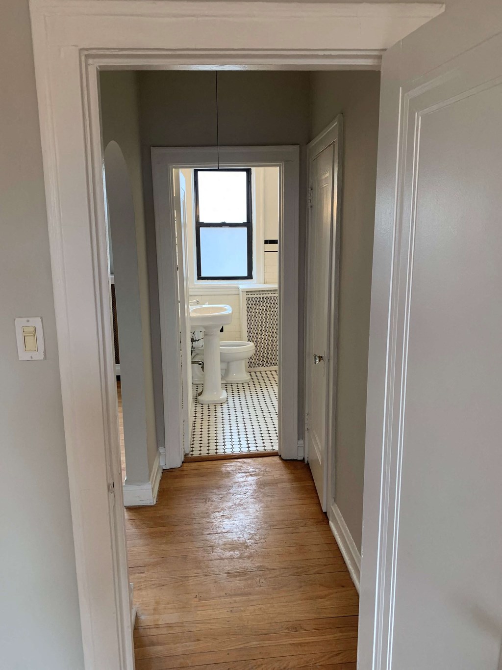 a bathroom with a toilet and a window