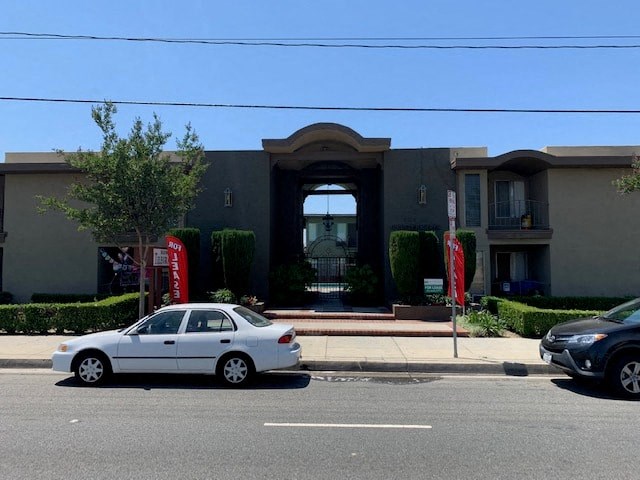 a white car parked in front of a building
