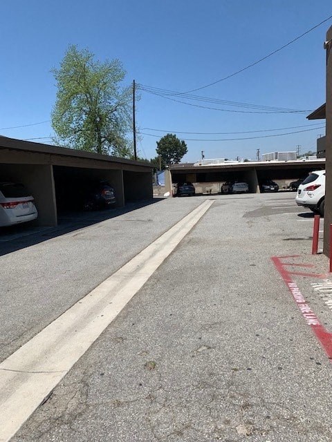 a street with cars parked under an overpass
