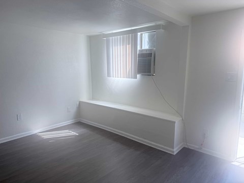 A room with a window and air conditioner.