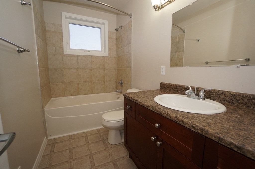 a bathroom with a sink and a toilet and a tub