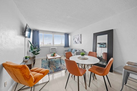 a dining room with a table and chairs and a living room