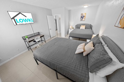 a bedroom with a bed and a couch and a desk