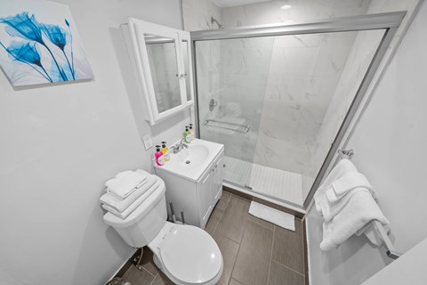 a bathroom with a toilet sink and a shower