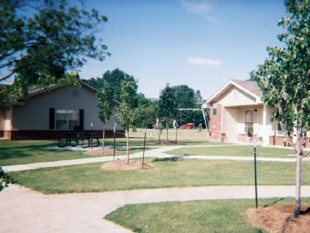 a yard with a playground and a house