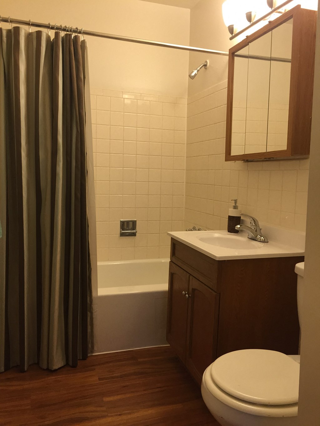 a small bathroom with a sink toilet and shower