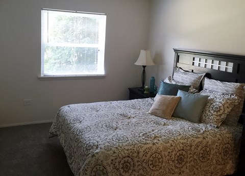 a bedroom with a bed and a window