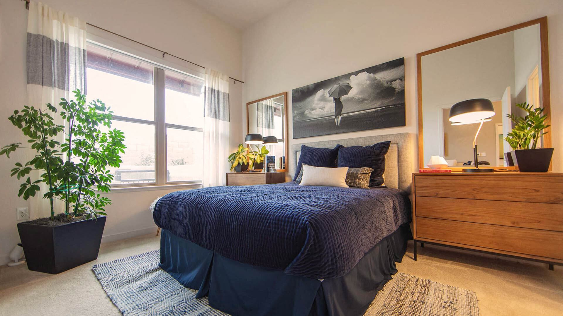 a bedroom with a bed and a potted plant
