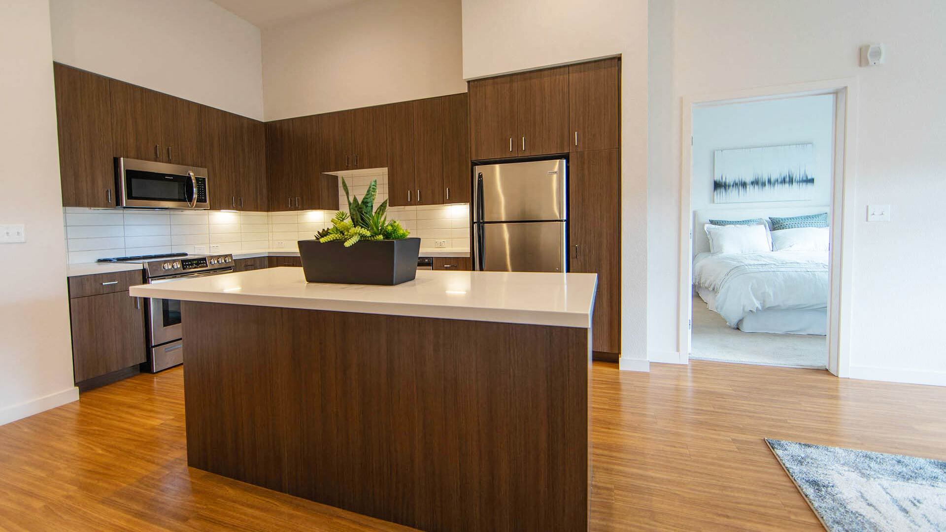a kitchen with a large island with a potted plant
