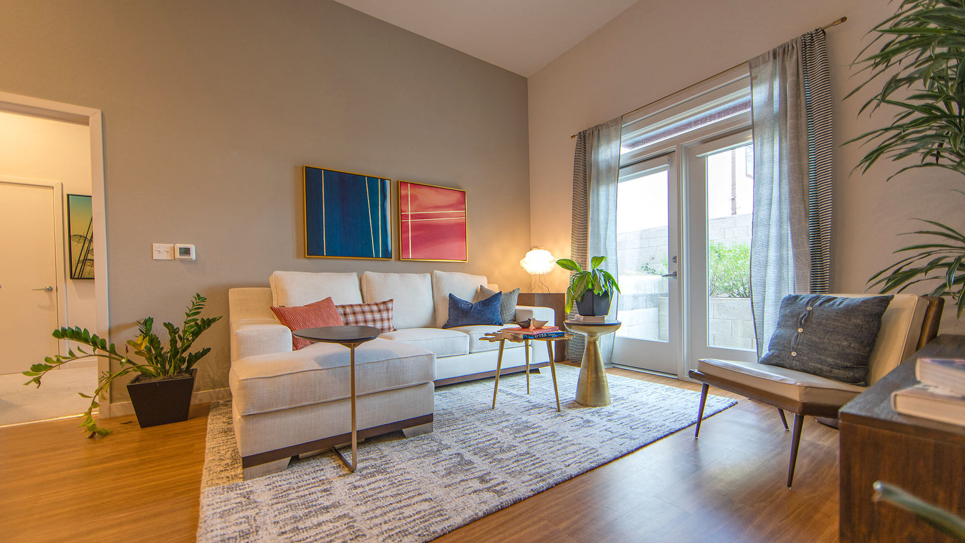a living room with a white couch and a large window