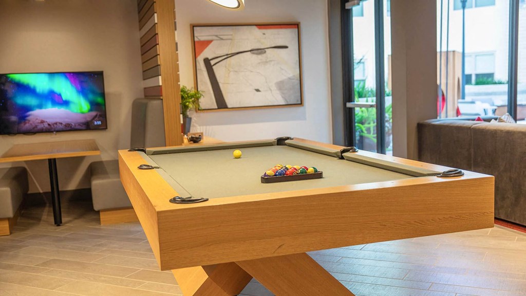 a games room with a pool table and a tv