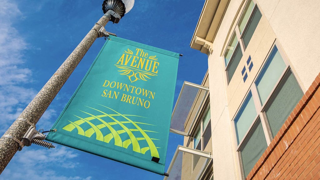 a sign for the avenue downtown outside of a building