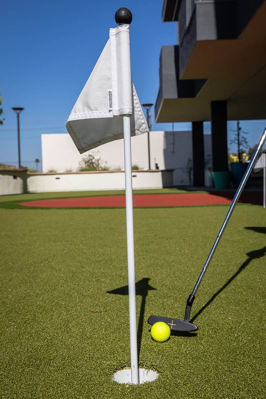 a yellow golf ball on a tee in the grass