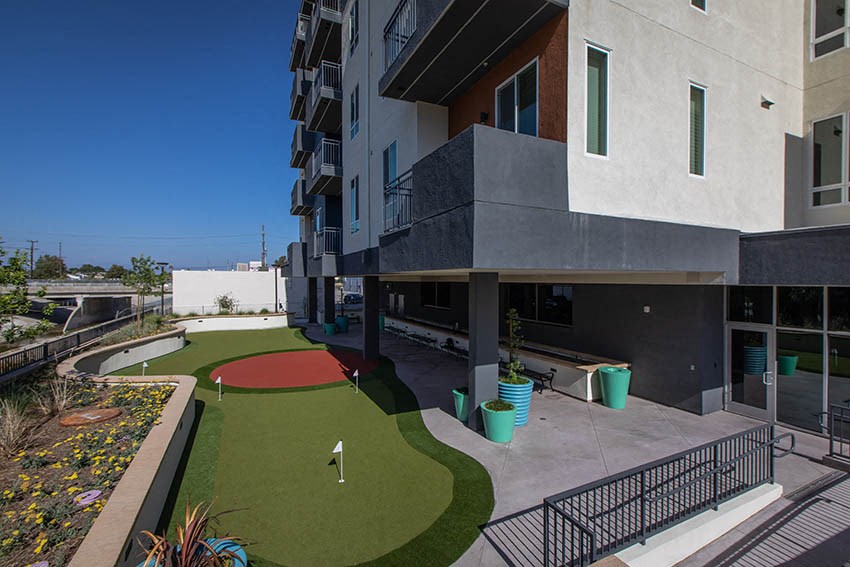 an apartment building with a golf course in front of it