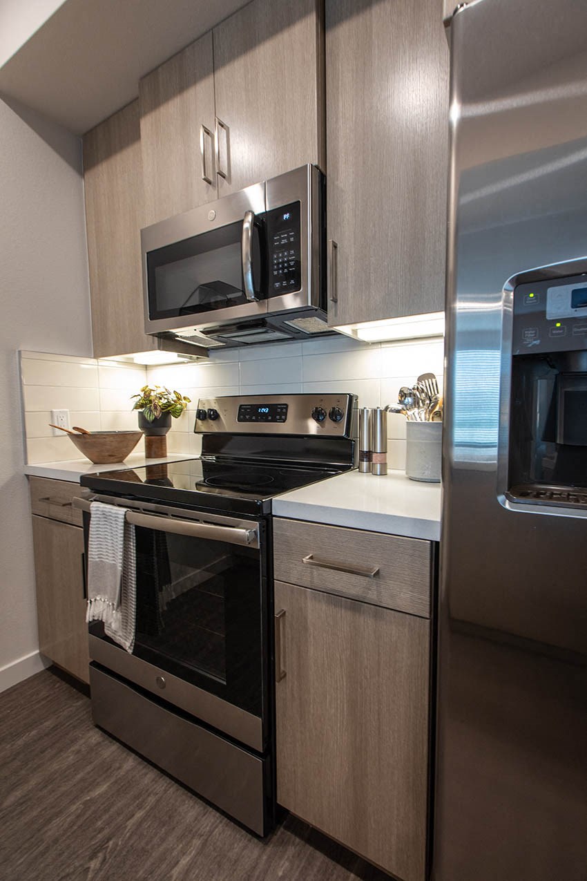 a kitchen with stainless steel appliances and a microwave